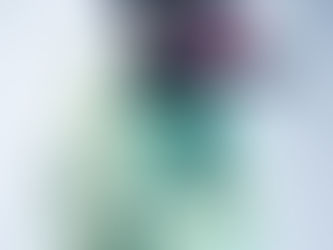 A model wearing a purple and green tulle and pleated dress. Thomas Alexander, 2025 MA Costume Design for Performance, London College of Fashion, UAL. Photograph by Sam Gallagher