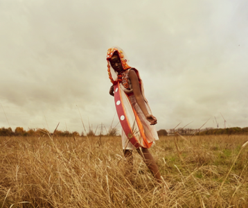 woman in a field wearing a design by Anustha Kishor
