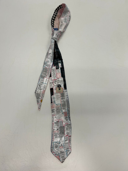 A tie made of care labels - a LCF student's work in response to the 'Pockets of Love' Dzaleka Arts Lab brief. 