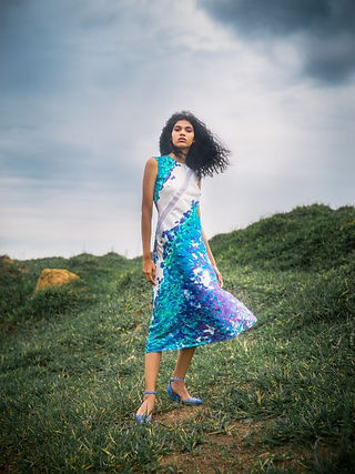 woman stood on grass in dress by Away to Mars