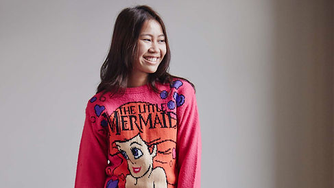 girl wearing jumper whilst smiling