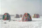 Multicoloured flag covered tents in antarctica in the snow