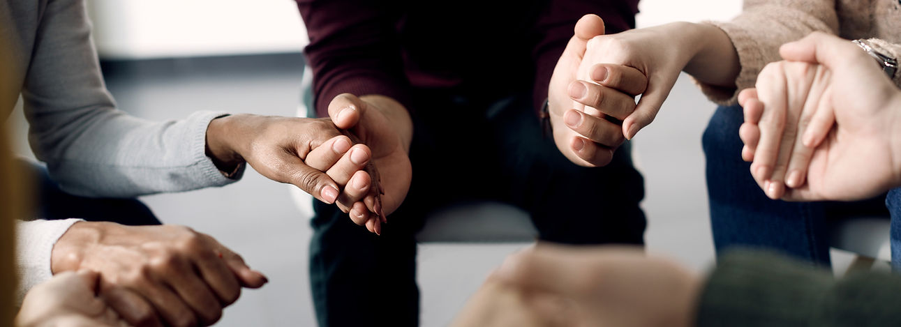 closeup-group-people-holding-hands-psychotherapy-session-(1).jpg