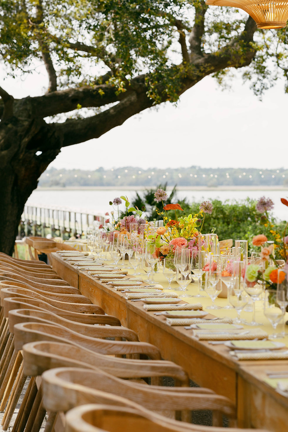 Outdoor reception tablescape with pink and peach floral centerpieces by Wilder Bloom Co.