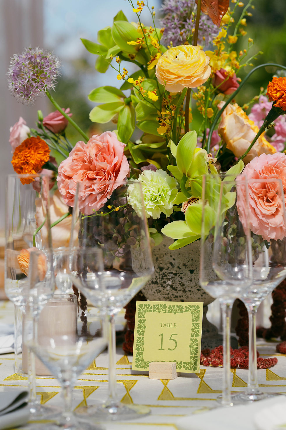 Peach and coral floral centerpiece by Wilder Bloom Co in glass vase.