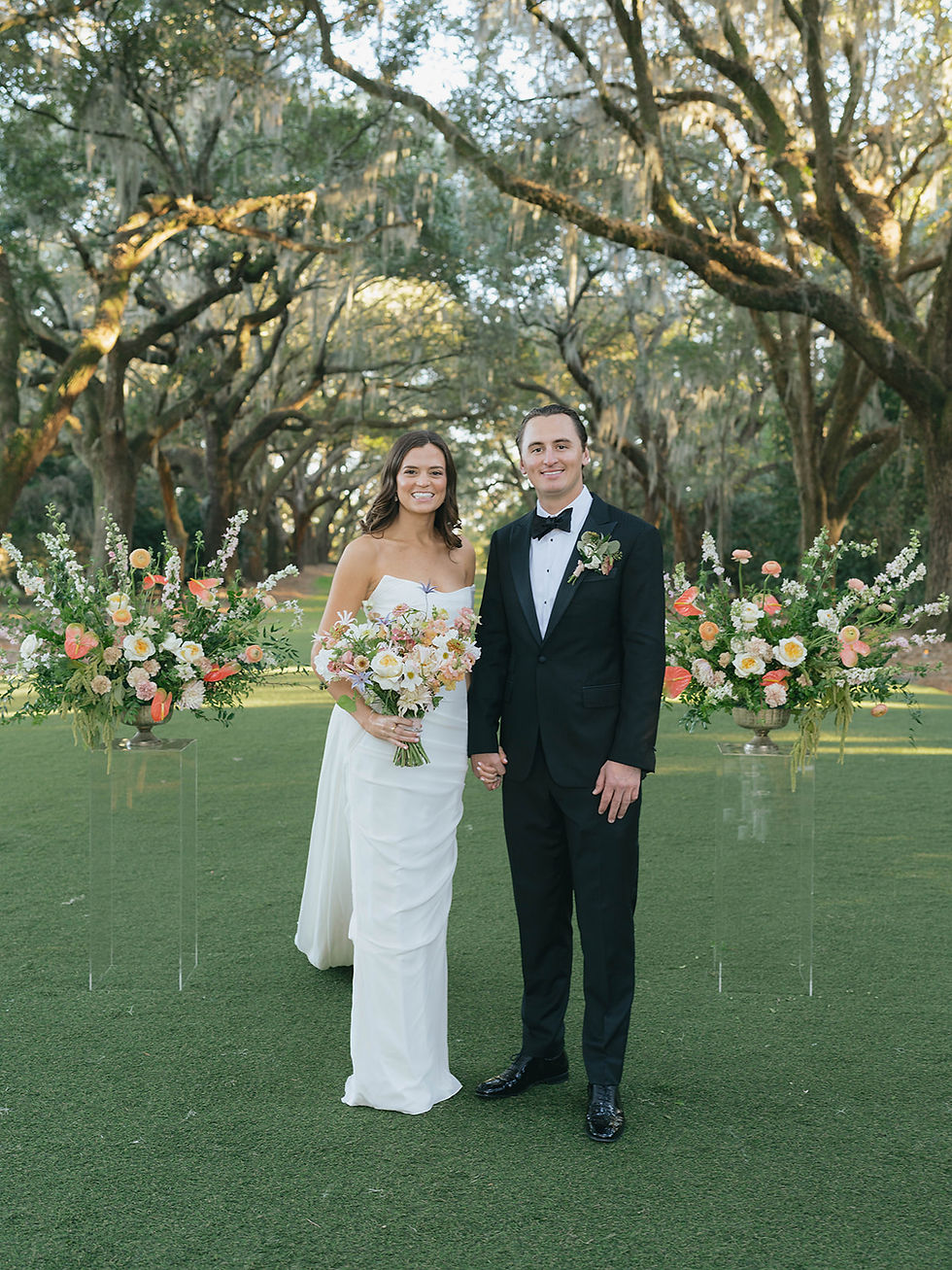 Bride and groom portrait in garden setting with bouquet by Wilder Bloom Co.