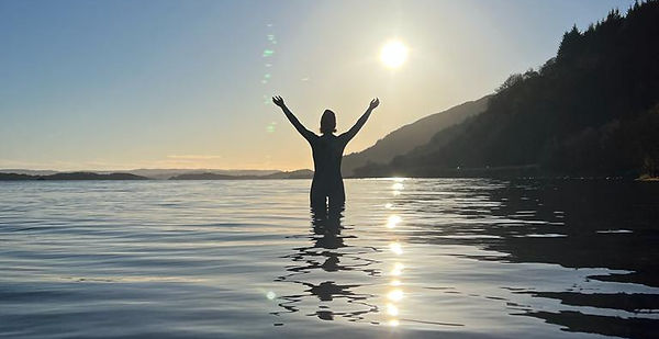 Loch Lomind woman in the water happy in sunshine