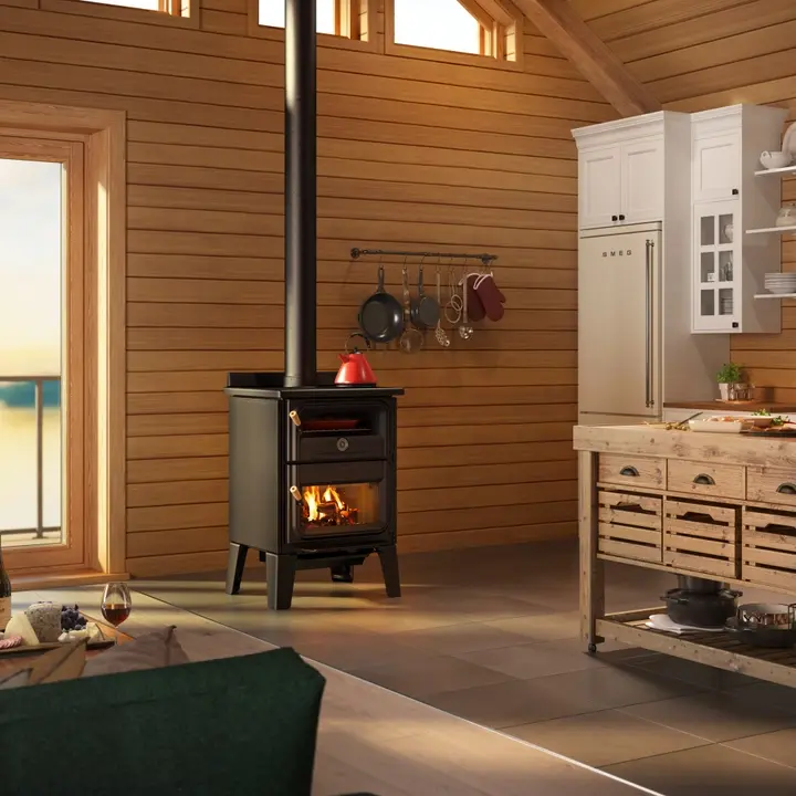 Black wood-burning stove with a fire inside, in a rustic kitchen with wooden walls