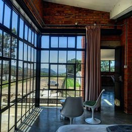 Unique modern accommodation at The Old Mushroom Farm. The Loft apartment is a newly renovated farm shed, on the first floor overlooking the picturesque farmland of the KZN Midlands. A modern farmstay for your weekend countryside getaway, Howick.