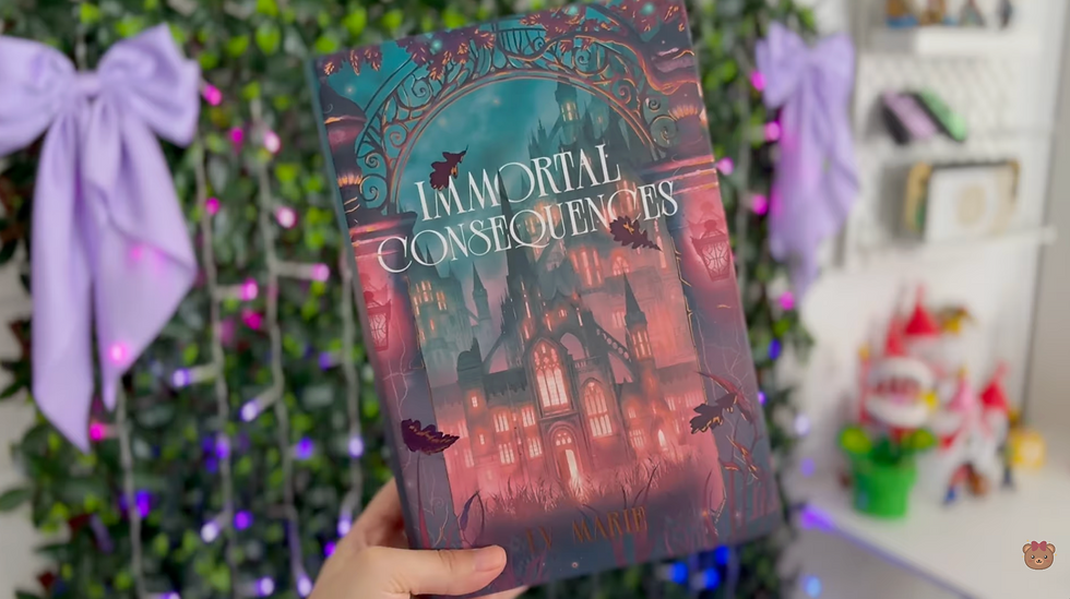 book titled "Immortal Consequences" by IV Marie with a gothic castle cover. Background includes a leafy gate, and colorful decor.