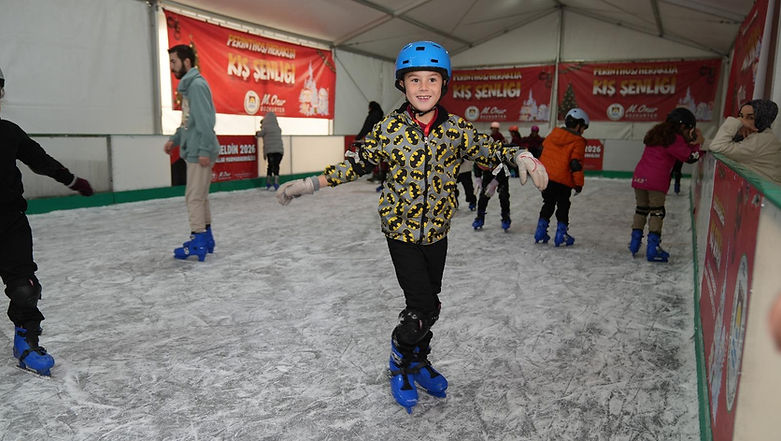 Boy skating at the tented winter festival ice rink