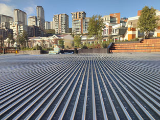 Aluminum box-profile collector piping laid out on-site before ice installation