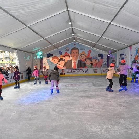 Children skating inside the tented real ice rink