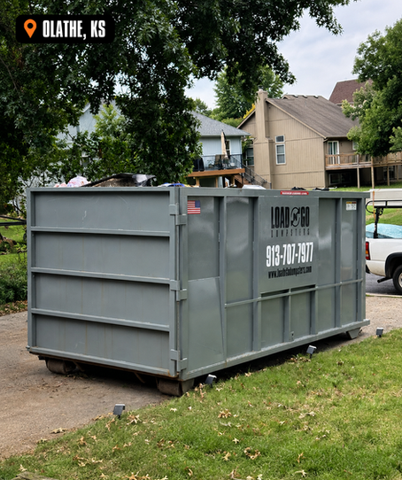 Load-N-Go 30-yard dumpster in a residential driveway during a home cleanout in Olathe, Kansas.