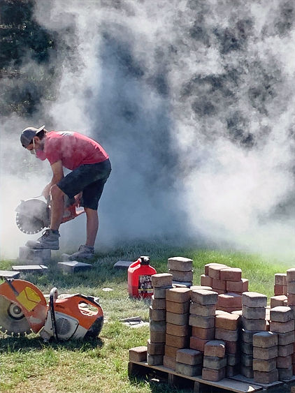 Arrowhead Hardscape Owner cutting brick paver for in-progress paver project.