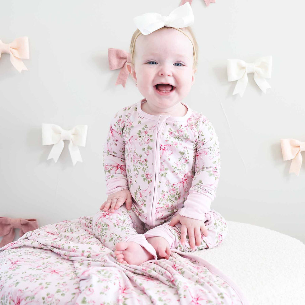 Baby wearing pink romper with pink flowers