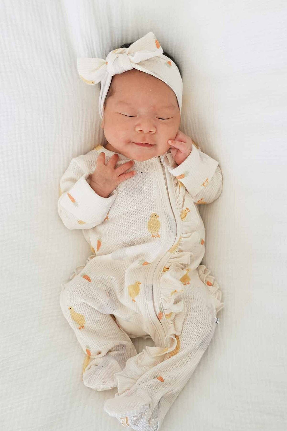 baby wearing headband with carrots and chicks