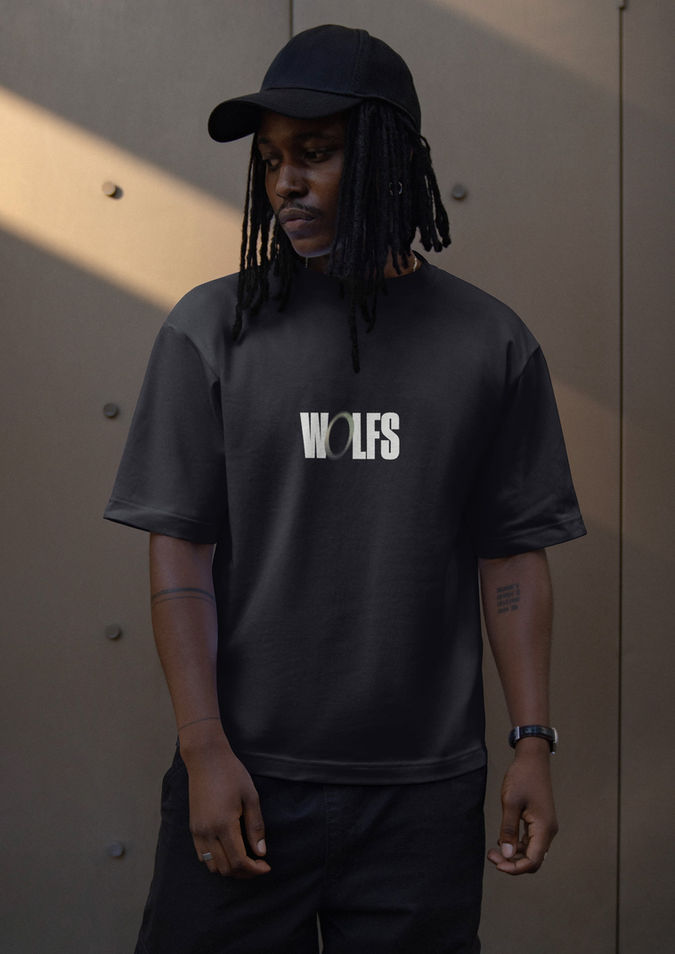 Model wearing WOLFS logo t-shirt highlighting modern brand identity and apparel design