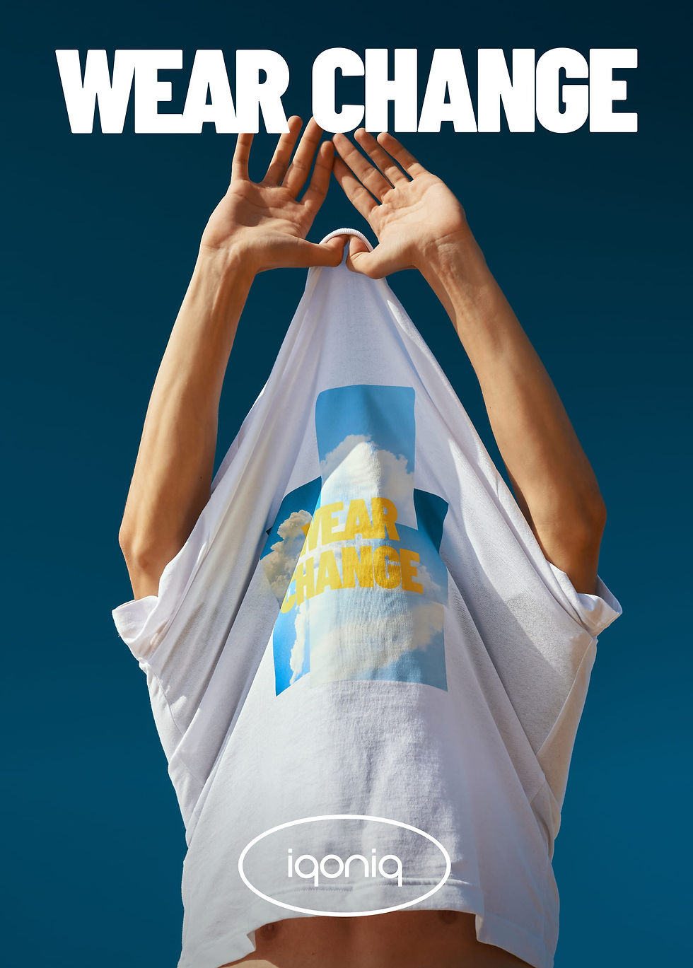 Sustainable fashion campaign image showing model lifting Wear Change t shirt against blue sky with iqoniq branding
