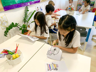 Students drawing at the table for Lunar New Year at Astor International School