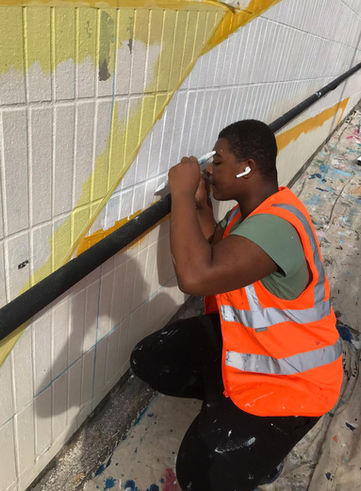 Our super volunteer and young local resident  in action 