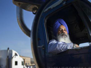 Sikh driver for Massachusetts Trucking Company at home in his cab.