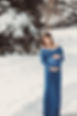 Pregnant woman holding her belly in the snow