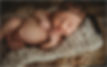 Newborn baby with dimple smiling while asleep