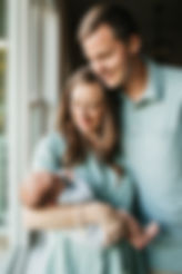 Couple holding their newborn