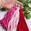 Thumbnail: A selection of red, hot pink and pink handmade tassels made with t-shirt yarn .