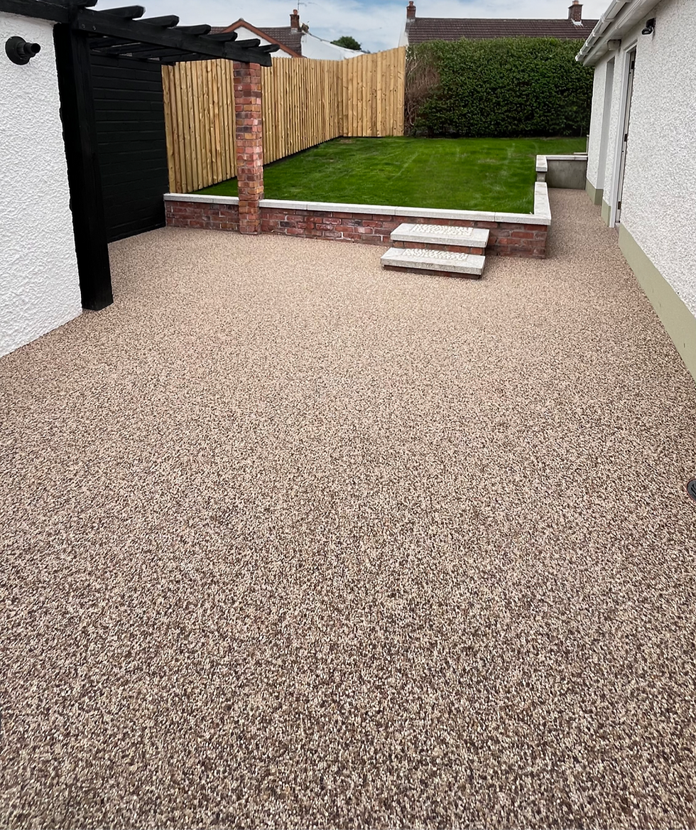 Resin bound patio with lawn and brick garden walls.