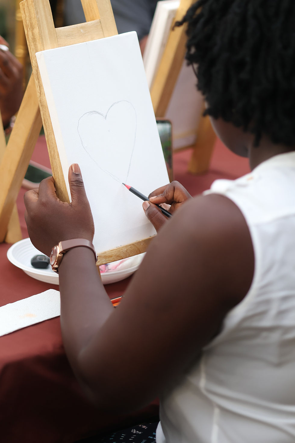 A girl sitting on top of a stack of books