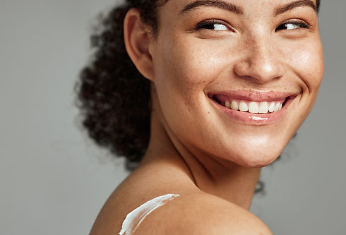 Smiling woman with cream on her back