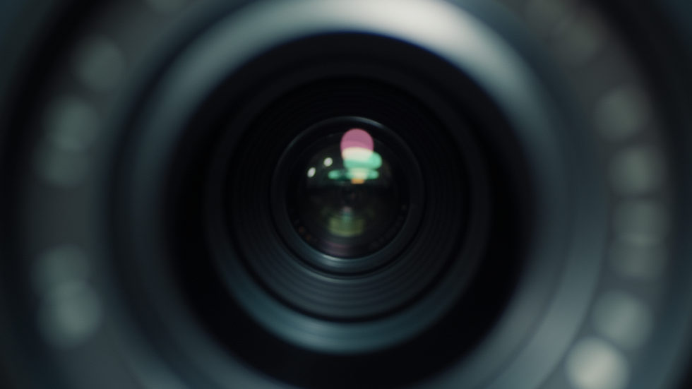 Close-up view of a high-end camera lens focused on a product shoot
