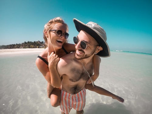 couple planning on beach in water.jpeg