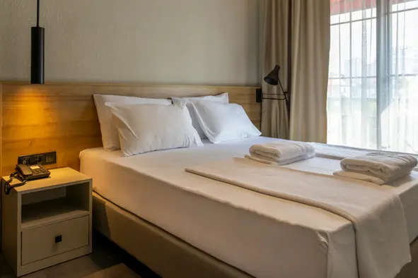 The elegant Standard Room of Hotel 7 welcomes its guests with a spacious French balcony.