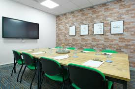 Training room at Bizspace showing 8 chairs with a table for learners and a TV on the wall