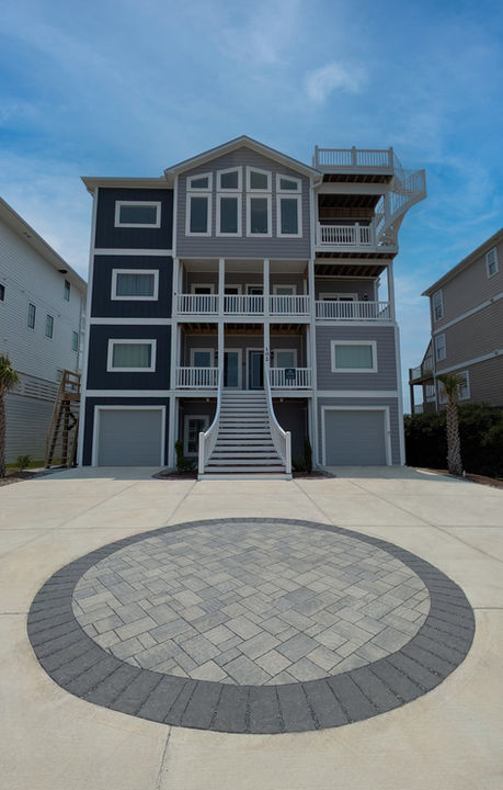Circular feature and surrounding walkways with random pattern permeable Techo-Bloc pavers by Lifeflow Services.
