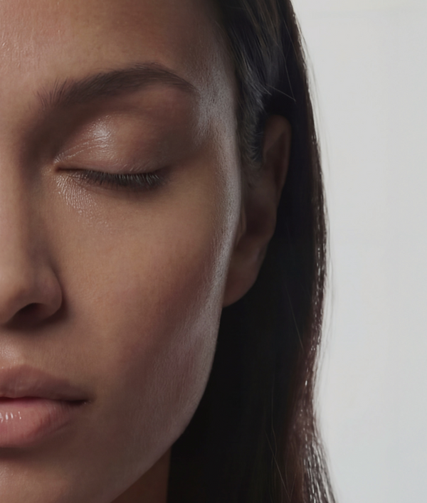 Half of a womans face with less blemishes