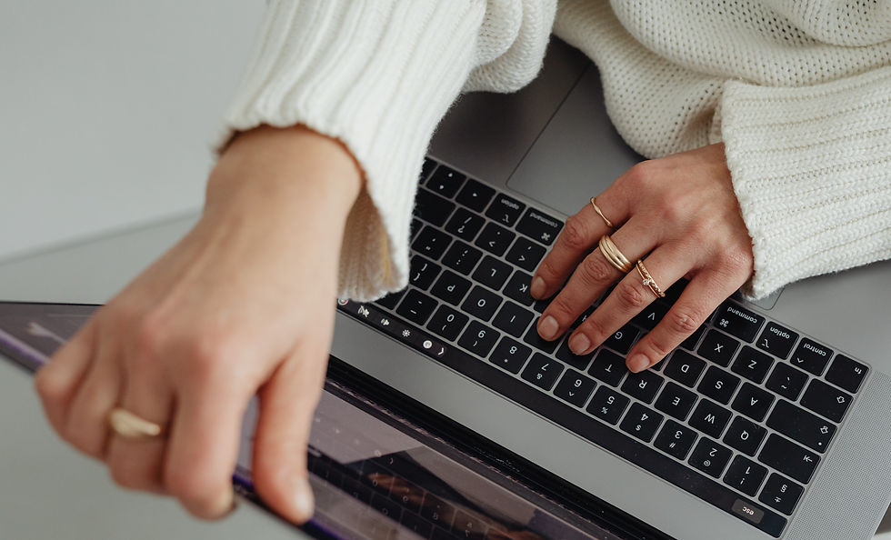 kaboompics_woman-in-white-sweater-gold-rings-jewelry-jeans-laptop-work-29445_edited.jpg