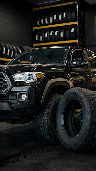 Black Toyota Tacoma in garage setting_Nero_AI_Image_Upscaler_Photo_Face_Compressed_edited.
