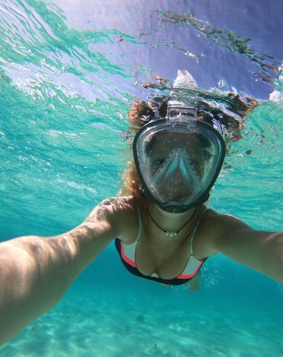 Guest snorkeling in clear turquoise waters during the Palomino Tiara 40 boat tour.