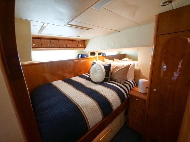 Elegant wood-finished private cabin and bed on the Just to Splash Neptuno 60 overnight yacht rental.
