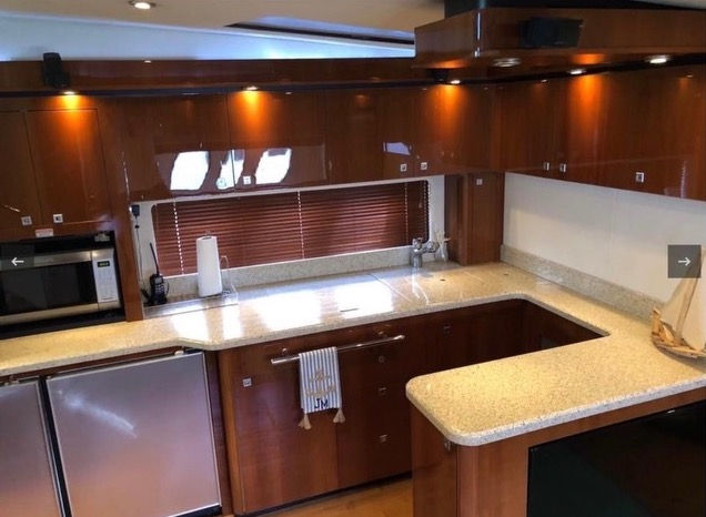 Modern wood-finished galley kitchen inside the Sea Ray 55 private boat rental in Fajardo.