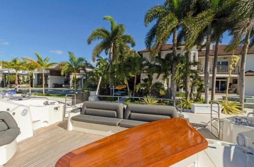 Aft deck view of the Ivy Sunseeker 82 luxury boat charter docked at the marina.