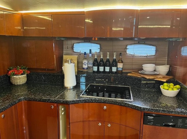 Interior wooden galley kitchen inside the Dakiti 60 luxury yacht charter.