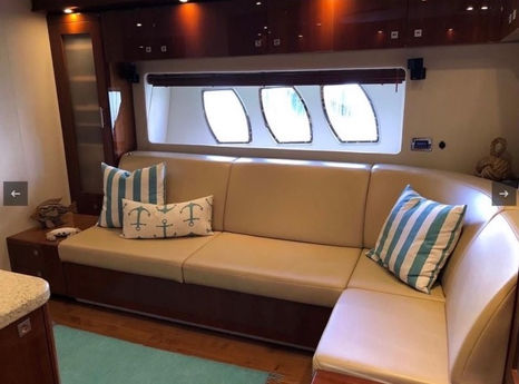 Air-conditioned interior saloon with plush L-shaped sofa on the Sea Ray 55 yacht.