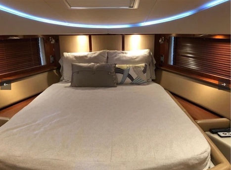 Luxurious master stateroom bed with ambient lighting inside the Sea Ray 55 yacht charter.