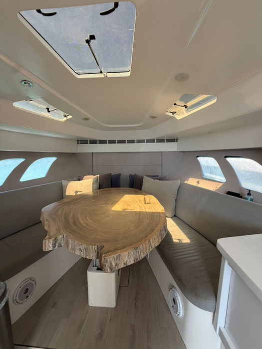 Air-conditioned interior cabin and dining table inside the Intrepid 47 private charter.