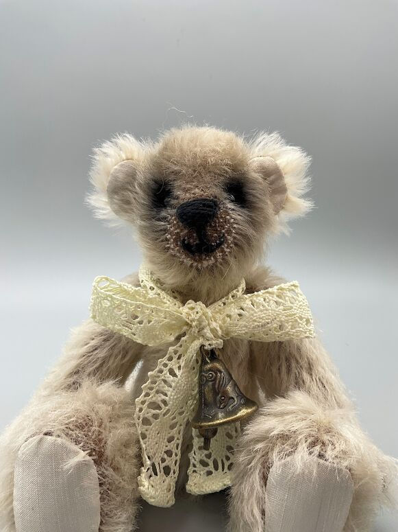 Fluffy teddy bear with lace bow and bell